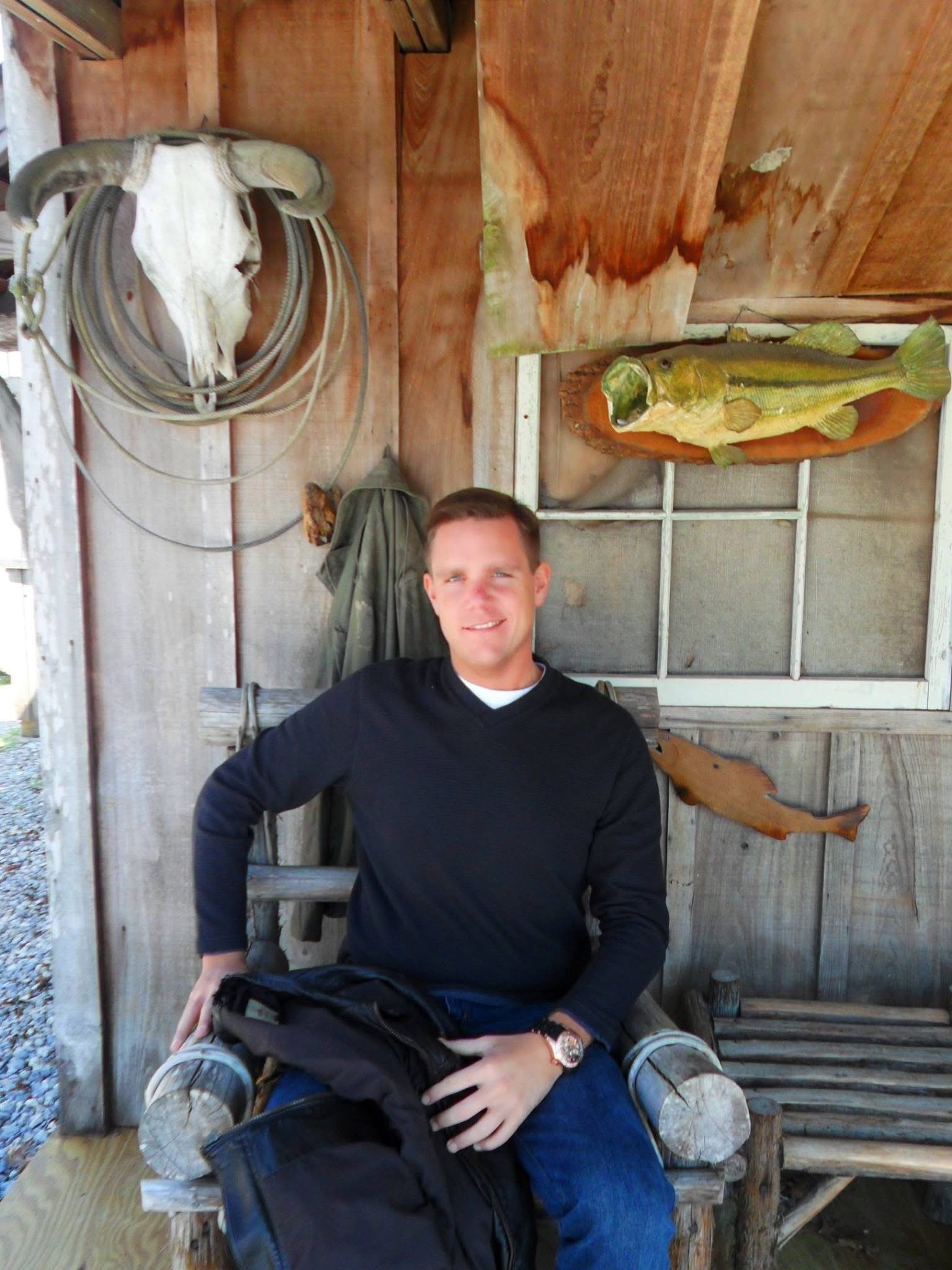 Ryan Barkley seated outdoors in a rustic setting